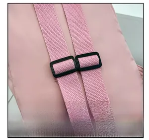 Detail of adjustable padded shoulder straps with black buckles on pink toddler backpack