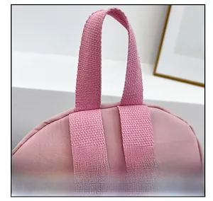 Detail showing durable fabric top handle and reinforced shoulder strap stitching