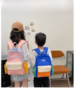 Detail view of colorful contrast canvas backpacks for children with fashion logo