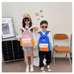 Detailed view of color-block kids backpacks showing large capacity and fashion patch