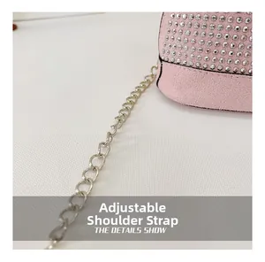 Detail showing pink suede mini bag with silver rhinestones and adjustable metal chain strap