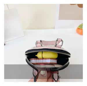 Detail view showing the spacious interior capacity of this pink rhinestone mini shell bag