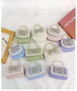 Detailed collection of mini lace pearl handbags with sparkling bowknots in various colors