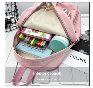 Detail view of the large capacity pink canvas backpack interior showing the storage pockets