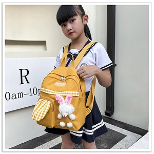 Detail of yellow kids backpack with a 3D plush bunny and stylish checkered pocket accents