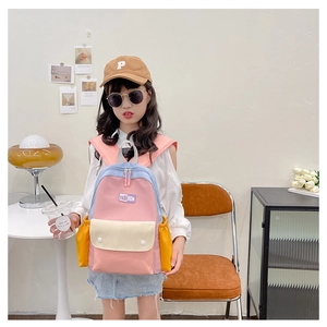 Detail view of colorful macaron contrast kids backpack with side pocket and fashion patch