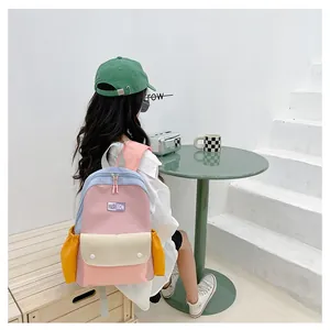 Detailed side view of color-block kids backpack with multiple storage pockets