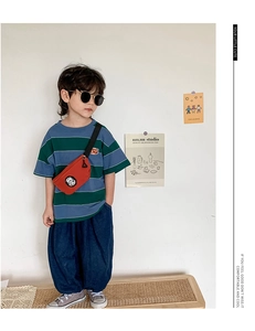 Close-up of a stylish red crossbody chest bag with round patch for kids outfit