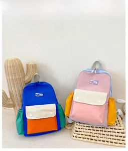Close-up of vibrant color-block kids backpacks featuring multi-pocket canvas design