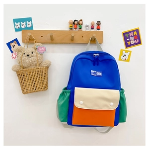 Detail of colorful kids' backpack with elastic side pockets and nylon fabric texture