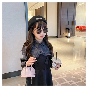 Toddler girl modeling a pink rhinestone shell crossbody bag with a chic fashion outfit