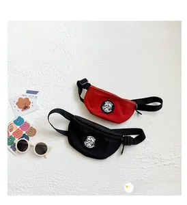 Detail view of mini nylon chest bags for kids in red and black with adjustable straps