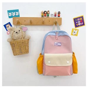 Close-up of kids' color-block backpack with durable nylon fabric and fashion woven label