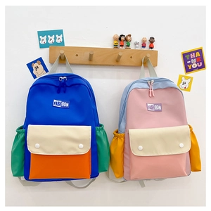 Detail view of colorful contrast kids backpacks with front pockets and side mesh storage