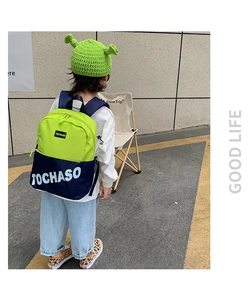 Détail d'un sac à dos enfant léger en nylon vert néon et bleu marine avec logo TOCHASO