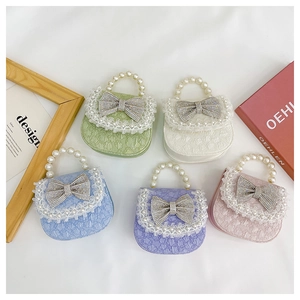 Detail of mini bags with rhinestone bows, lace pearl edges, and beaded handles in pastel colors
