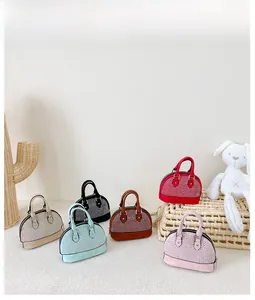 Macro view of six colors of shell-shaped mini handbags with sparkling silver rhinestones