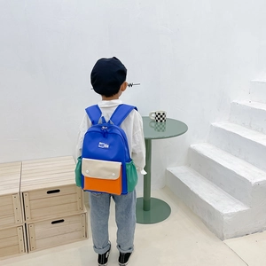 Child wearing high-capacity color-block canvas backpack for school and travel