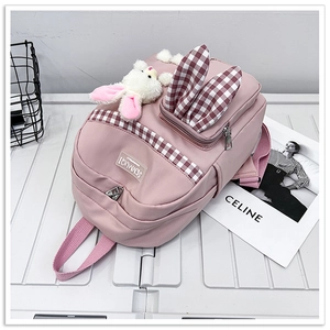 Pink nylon kids backpack featuring cute rabbit ears and a soft plush bunny charm