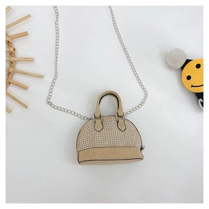 Close-up of mini shell-shaped crossbody bag with sparkling rhinestones and silver chain