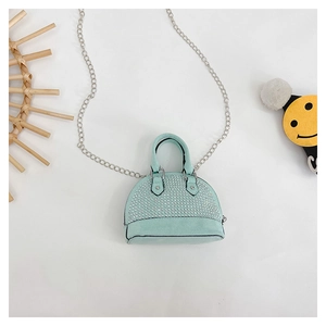 Detail of mint green shell crossbody bag with silver rhinestones and metal chain strap
