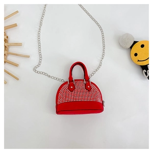 Macro shot of red shell purse with sparkling rhinestones and silver metal chain strap