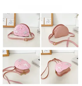 Detail view of pink glitter shell bag with starfish accents and adjustable strap