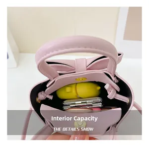Internal view of pink bow handbag showing storage for earbuds and makeup palettes