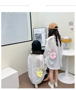 Detailed view of pink and yellow PU crossbody bags with cute bow for kids
