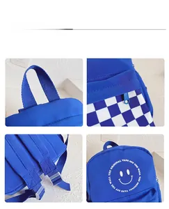 Detail of blue canvas kids backpack with smiley face and checkerboard pattern