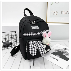 Detail of cute rabbit ears design and checkered pattern on kids canvas backpack