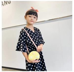 Close-up of yellow semi-circle crossbody bag with colorful sequin starfish for kids