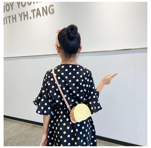 Girl's mini crossbody bag with yellow sequins and colorful starfish patterns on model
