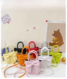 Flat lay of colorful mini bow handbags in various pastel and vibrant PU leather shades