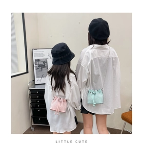 Matching mini woven bucket bags for mothers and girls with chain straps and drawstrings
