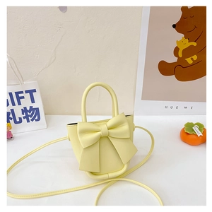 Mini yellow PU leather handbag with a large bow and shoulder strap for girls