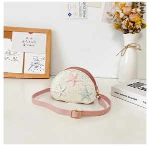 Pink semi-circle girl's crossbody bag with sequins and 3D starfish charms detail