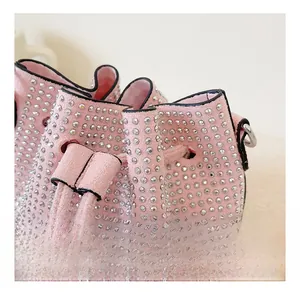 Detailed macro view of pink suede bucket bag with hand-set sparkling silver rhinestones