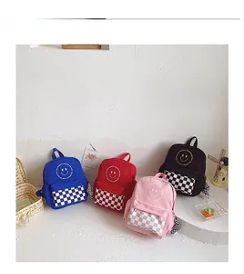 Mini children's smiley backpacks in multiple colors with checkered pockets and charms