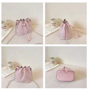 Detail of pink rhinestone bucket bag with drawstring closure and metal chain strap