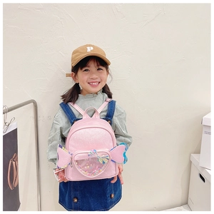 Detail of pink glitter toddler backpack featuring heart window and fairy wings decoration