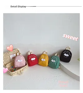 Detail display of small canvas kids backpacks in five colors with cute angel wings