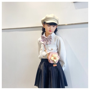 Pink flower-shaped crossbody bag for girls with plush center and dangling pompom details