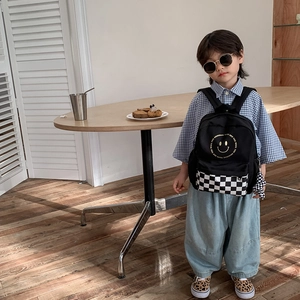 Kids black backpack with yellow smiley face and checkerboard pocket for kindergarten