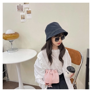 Close-up of pink rhinestone bucket bag for girls with silver chain strap and drawstring