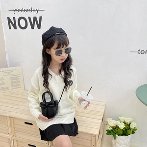 Mini PU bow shoulder bag paired with cream knit sweater and black pleated skirt