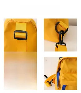 Detail of yellow canvas kids chest bag with blue zipper and black adjustable buckle