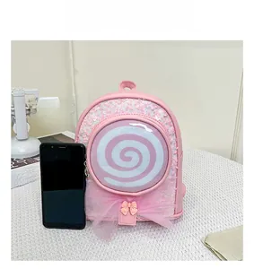 Pink sequin mini backpack with lollipop design shown next to a smartphone for size reference