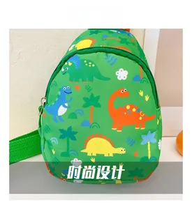 Close-up of green canvas kids chest bag featuring colorful cartoon dinosaur prints