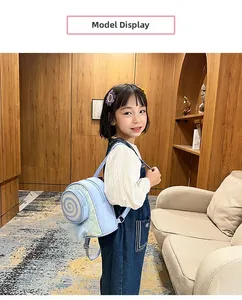 Toddler girl wearing light blue lollipop backpack with sequins in home setting